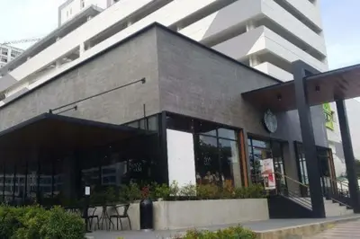 a building with a clock on the side of it at Grace Residences Condotel Paris & Singapore Concept Near McKinley in Manila