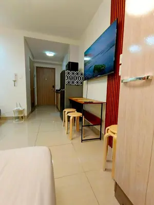 a living room with a table and chairs in a room at Shore 2 Residences T1, MoA WTC SMX Arena 1br 4pax in Manila