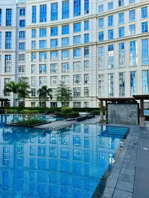 a large building with a pool in front of it at 81 Newport Blvd Cluster 4 Unit B 3rd flr by Rechelle Nunag in Manila