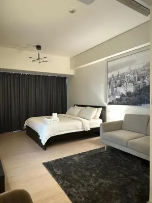 a hotel room with a bed and a couch at 81 Newport Blvd Cluster 4 Unit B 3rd flr by Rechelle Nunag in Manila