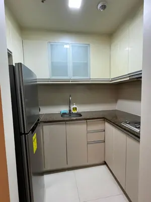 a small kitchen with a sink and a refrigerator at 81 Newport Blvd Cluster 4 Unit B 3rd flr by Rechelle Nunag in Manila