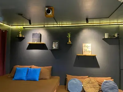 a room with a couch and some lights on a wall at EL MEIR STAYCATION SMART CINEMA CABIN BESIDE ENCHANTED KiNGDOM in Santa Rosa
