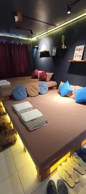 a large bed with many pillows on it in a room at EL MEIR STAYCATION SMART CINEMA CABIN BESIDE ENCHANTED KiNGDOM in Santa Rosa