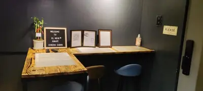 a desk with a chalkboard on top of it at EL MEIR STAYCATION SMART CINEMA CABIN BESIDE ENCHANTED KiNGDOM in Santa Rosa