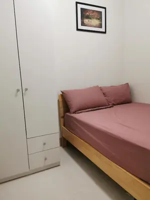 a bedroom with a bed and a cabinet at Shore 3 in Manila