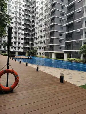 a large building with a swimming pool in front of it at Shore 3 in Manila
