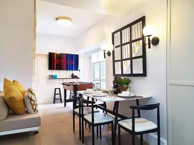 a dining room with a table and chairs at BGC - Two Bedroom Condo with Game Room high speed WiFi in Manila