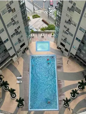 an overhead view of a swimming pool in a building at BGC - Two Bedroom Condo with Game Room high speed WiFi in Manila
