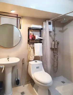 a bathroom with a toilet and a sink at BGC - Two Bedroom Condo with Game Room high speed WiFi in Manila