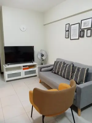 a living room with a couch and a tv at Asteria Residences Annabel CozyPlace highspeed wifi in Manila