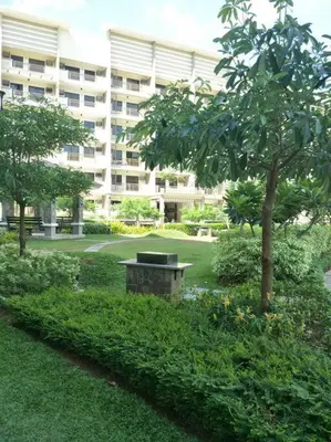 a park with a bench in front of a building at Asteria Residences Annabel CozyPlace highspeed wifi in Manila
