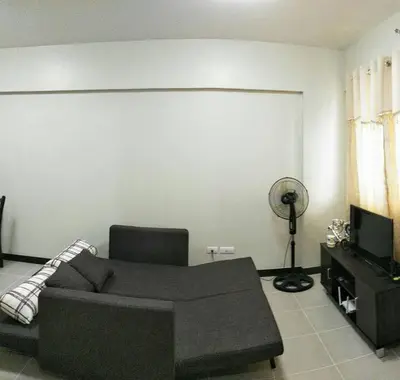 a living room with a couch and a television at Asteria Residences Annabel CozyPlace highspeed wifi in Manila