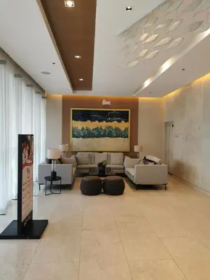 a living room with couches and a painting on the wall at Shore 3 tower 2 mall of Asia in Manila