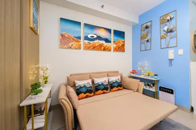 a living room with a couch and a table at 3 Condos*8 Beds*3 bathrooms*3 Kitchens*4 Pools*@ Shore2 MOA in Manila