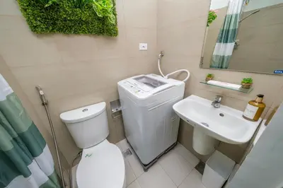 a small bathroom with a toilet and a sink at 3 Condos*8 Beds*3 bathrooms*3 Kitchens*4 Pools*@ Shore2 MOA in Manila