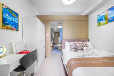 a bedroom with two beds and a desk with a computer at 3 Condos*8 Beds*3 bathrooms*3 Kitchens*4 Pools*@ Shore2 MOA in Manila