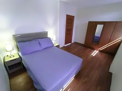 a bedroom with a large bed and two lamps at Casa Maris in Bacoor