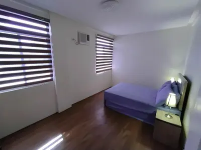 a small bedroom with a bed and a window at Casa Maris in Bacoor