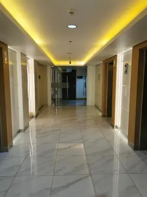 an empty hallway in a building with ailed floor at Shore 3 residence in Manila