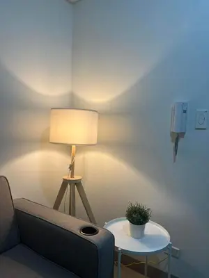 a room with a couch and a table with a lamp at Casa Florencia in Manila