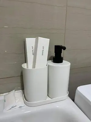 two white buckets sitting on top of a toilet at Casa Florencia in Manila