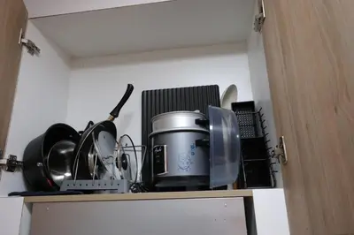 a cabinet with a bunch of items on top of it at Modern Studio Condo near Mall of Asia & Airport, Shore 2 Residences in Manila