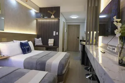 a hotel room with two beds and a counter at Modern Studio Condo near Mall of Asia & Airport, Shore 2 Residences in Manila