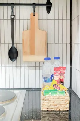 a basket of groceries and a bottle of water on a counter at Shore 3 Mall of Asia - Sofian Suites in Manila