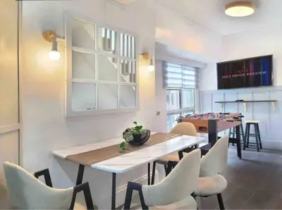 a dining room with a table and chairs and a game room at BGC - Two Bedroom Condo with Game Room with 400mbps WiFi- 09 in Manila