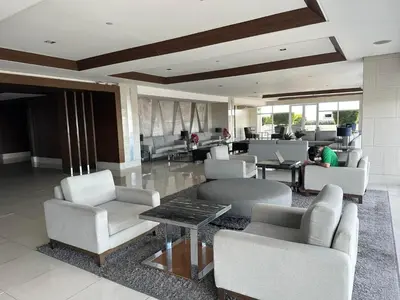 a person working on a laptop in a lobby at Elane's Staycation -Mezza 2 1 br in Manila