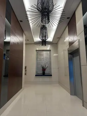 a hallway with a large chandelier in a building at Elane's Staycation -Mezza 2 1 br in Manila