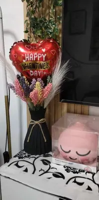 a vase with a happy valentines day sign and flowers at Smdc Breeze Residence in Manila