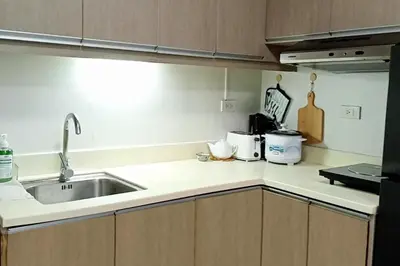 a kitchen with a sink and a counter top at Fully-furnished Condo Accommodation in Makati in Manila