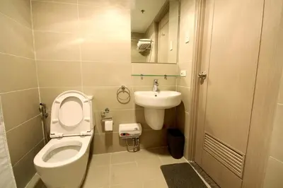 a small bathroom with a toilet and a sink at Fully-furnished Condo Accommodation in Makati in Manila