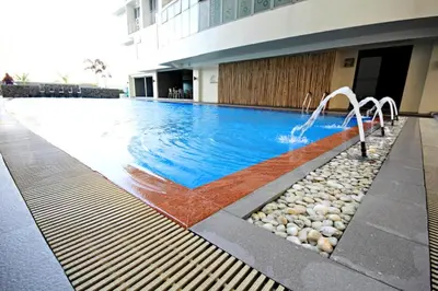 a swimming pool in front of a building at Fully-furnished Condo Accommodation in Makati in Manila