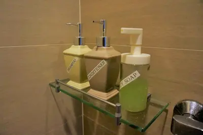 two soap dispensers on a wall in a bathroom at Eighty One Building C53J Condotel in Manila