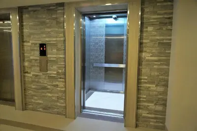 a shower with a glass door in a building at Eighty One Building C53J Condotel in Manila