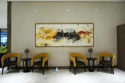 a waiting room with chairs and a painting on the wall at Eighty One Building C53J Condotel in Manila