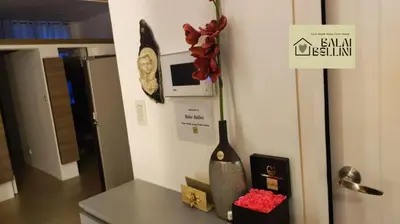 a kitchen counter with a vase and a sign on the wall at Condo in McKinley Hill near Grand Canal Mall (Balai Bellini) in Manila
