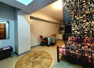 a dining room with a table and a table and chairs at Backpackers Transient Room in Manila