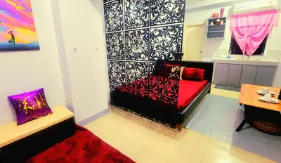 a living room with a couch and a table at Backpackers Transient Room in Manila