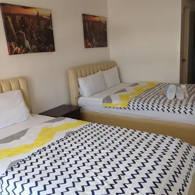 two beds sitting next to each other in a room at Birch Tower by The Bay in Manila