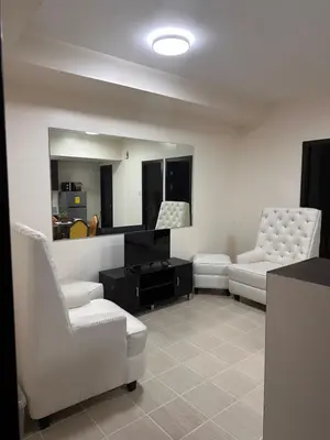 a living room with two chairs and a mirror at The Ivory San Lorenzo Place Makati in Manila