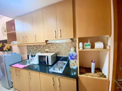 a kitchen with a counter with a microwave on it at Macc Staycation Shell Residences Moa in Manila