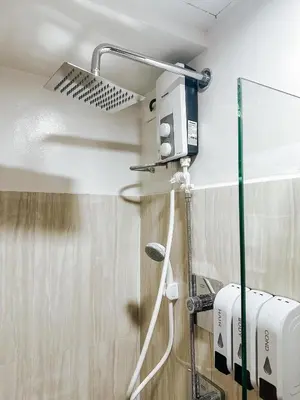 a shower in a bathroom with a shower head at Lian Louise at SMDC Shore 3 MOA with Parking in Manila