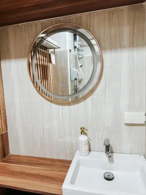 a bathroom with a sink and a mirror at Lian Louise at SMDC Shore 3 MOA with Parking in Manila