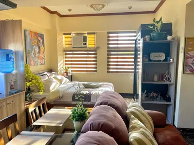 a living room with a couch and a table at Condo in Malate Manila in Manila
