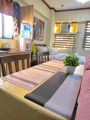 a kitchen with a table with three mats on it at Condo in Malate Manila in Manila