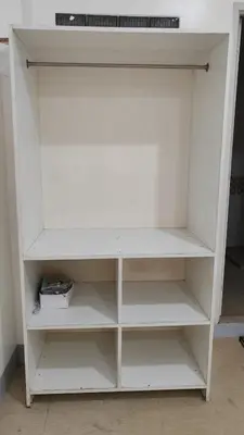 a white book shelf in a room at V hotel paranaque in Manila