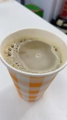 a cup of coffee sitting on a table at V hotel paranaque in Manila